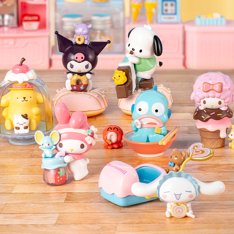 Colorful collection of Sanrio-style collectible figurines and dessert-themed character toys displayed on a wooden tabletop.