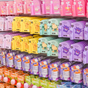 Colorful retail display of character-themed lip balms and lip creams inspired by Kirby, Pokémon, and Care Bears.